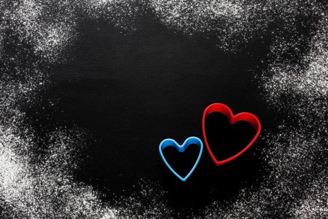 Flat lay colorful heart shapes with flour copy space