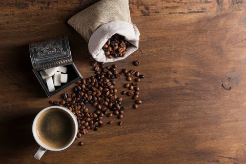Sack with coffee beans near box sugar cup