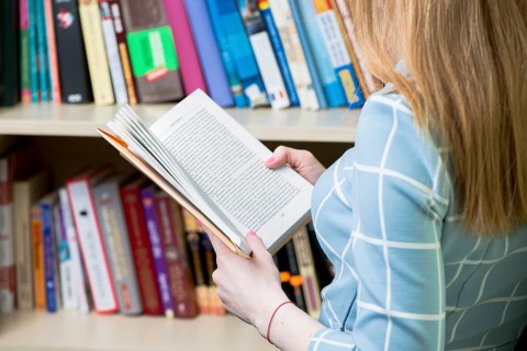 Close up girl reading book library