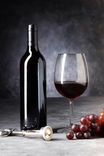 Red bottle wine half empty glass