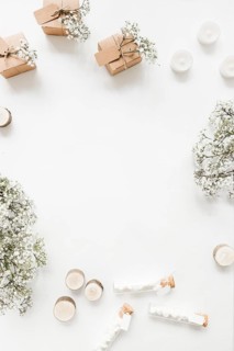 Gift boxes candles marshmallow test tubes baby s breath flowers white background