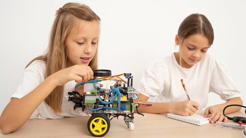 Two young girls doing science experiments together