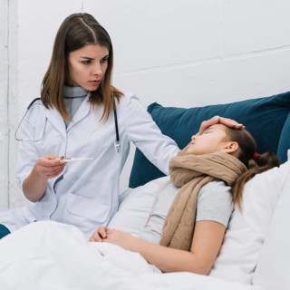 Female doctor measuring temperature her sick patient lying bed