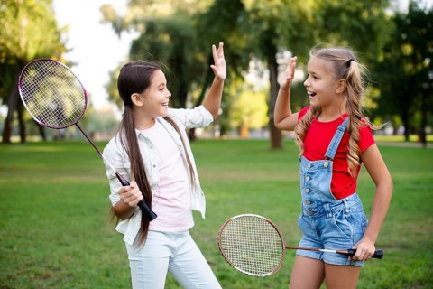 Little badminton players giving five
