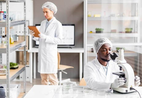 Female male researchers biotechnology laboratory with microscope tablet