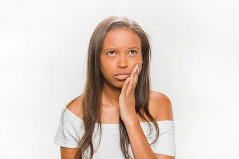 Portrait teenage girl suffering from tooth pain