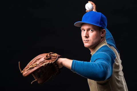 Baseball player with glove throwing ball