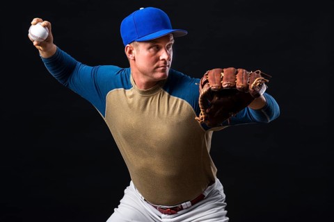 Man posing with baseball glove ball