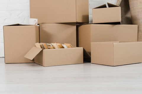 Pile cardboard boxes white floor