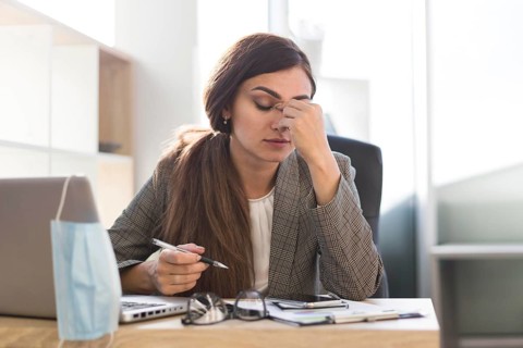 Tired businesswoman working desk with laptop