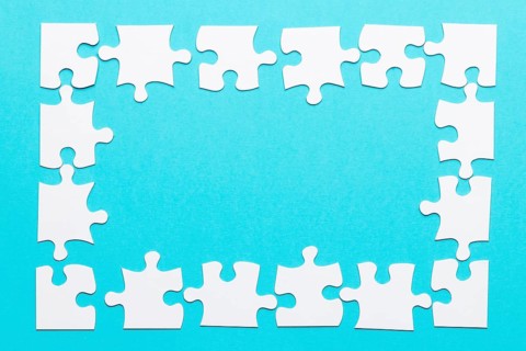High angle view jigsaw puzzle frame blue backdrop