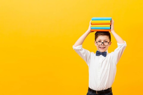 Copy space boy holding stack books