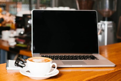Frontview laptop coffee wooden surface