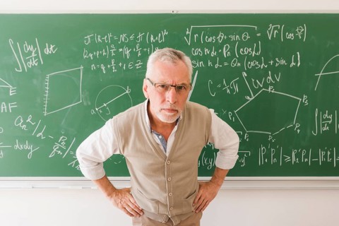 Serious aged professor lecture room looking camera