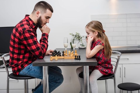 Father daughter playing chess fathers day