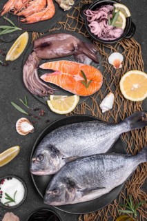 Fresh uncooked seafood fish various plates