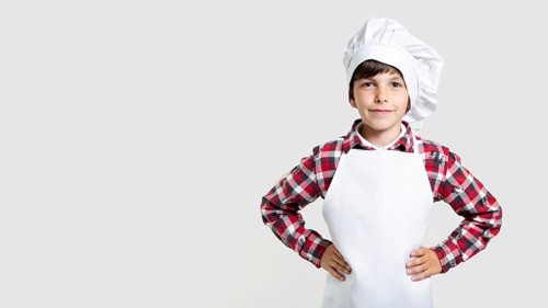 Cute young boy posing as chef