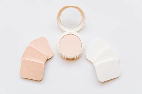 Face cosmetic compact makeup powder with sponges white background