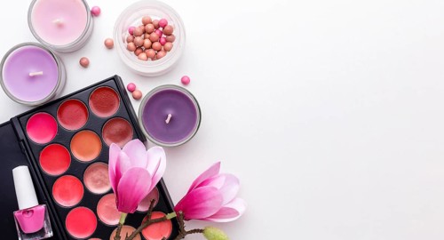 Top view make up products candles with copy space