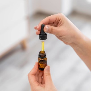 Close up hands holding serum