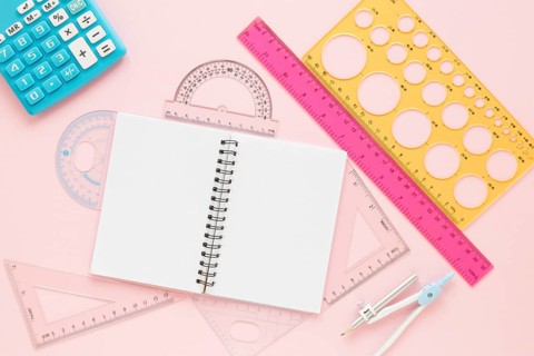 Math rulers supplies with open empty notebook flat lay