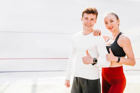 Medium shot sporty couple approving