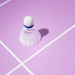 High angle shuttlecock purple background