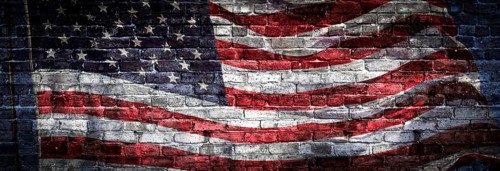 American flag over rough brick wall background banner