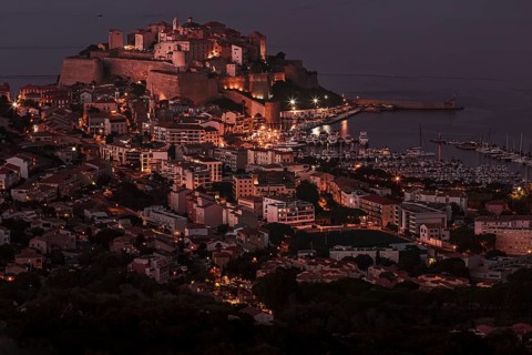 The illuminated town of Calvi at night on the northwest coast of Corsica France Europe