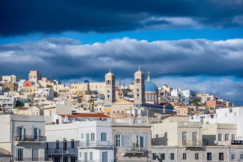 View of the town of Ermoupoli with pastel-coloured houses and the church of St Nicholas
