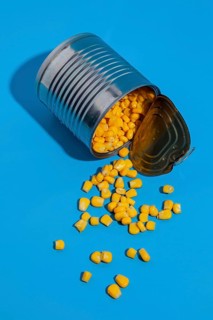 Overturned tin can filled with corn