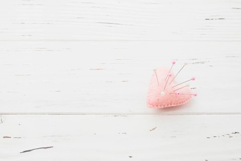 Sewing pins pink heart shape cushion