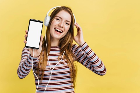 Happy woman listening music phone mock up