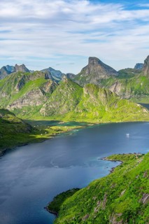 Mountain landscape with pointed mountain peaks and fjord Forsfjorden with village Vindstad