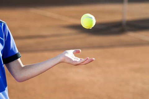 Kid playing with tennis ball