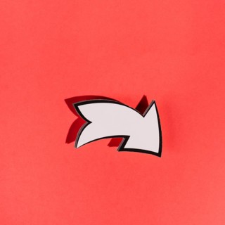 White directional arrow red background