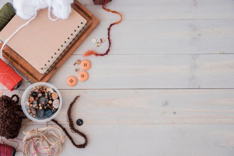 Wools beads string spool wooden desk