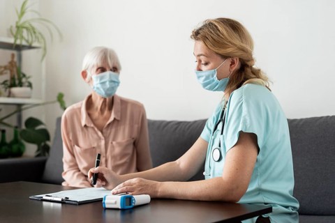 Nurse senior woman during check up nursing home