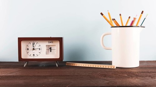 Ruler pencils near clock
