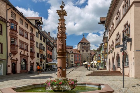 Apostle's Fountain and Old Town with old traditional houses with oriels in Black Forest style and Black Gate