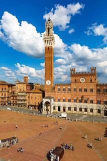 Spring clouds over the Piazza del Campo with the bell tower Torre del Mangia and the town hall Palazzo Pubblico