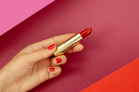 Top view woman holding red lipstick