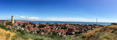 Panorama of the small town of West on Terschelling with the landmark Brandaris and view of the Wadden Sea