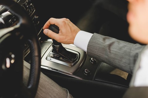 Elevated view businessman driving car moving transmission shift gear