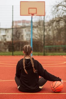 Teenager posing basketball field