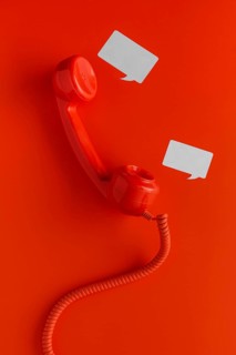 Top view telephone receiver with cord chat bubbles