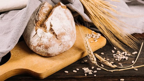 Loaf bread ear wheat dark wooden background
