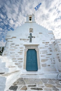 White Greek Orthodox Church Holy Church of Agios Konstantinos with Greek flag