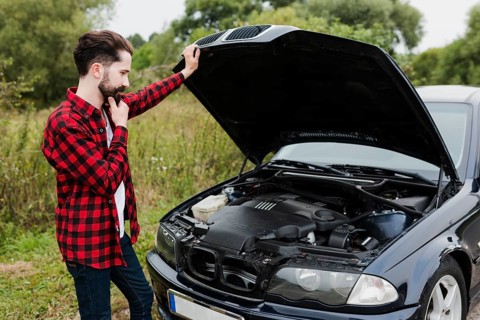 Man leaning open car hood