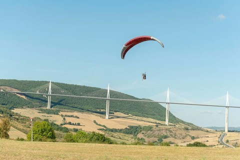 Paraglider in front of the Millau Bridge. Grands Causses